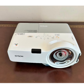 Buy the Epson PowerLite 410W 3LCD short throw projector with WXGA resolution, 2,000 ANSI lumens, built-in speaker, power cord, and VGA to HDMI adapter. EX-USA tested.