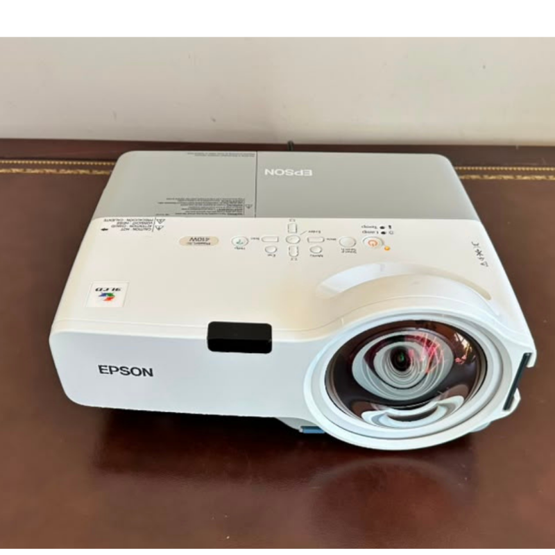 Buy the Epson PowerLite 410W 3LCD short throw projector with WXGA resolution, 2,000 ANSI lumens, built-in speaker, power cord, and VGA to HDMI adapter. EX-USA tested.